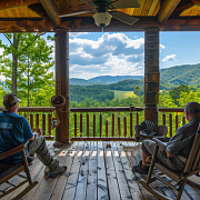 guys relaxing on the porch of a smoky mountains cabin rental