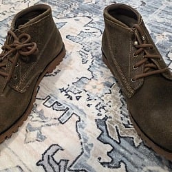 Wolverine 1000 Mile Legacy Cort Boot pair on a patterned rug, top-down view showing roughout suede chukka uppers with brown laces and rubber lug outsoles