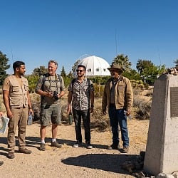Group of guys standing near the Integratron dome in Joshua Tree California desert