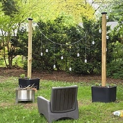 Step2 Firefly String Light Pole Stand with Planter installed in a backyard hangout zone with Solo Stove firepit and Step2 Switchback patio chair