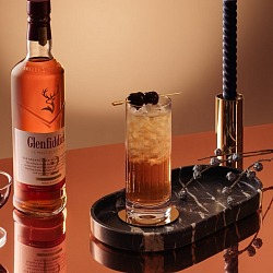 Glenfiddich Speyside Cobbler fall whiskey cocktail beside a bottle of Glenfiddich 12 Year Old Sherry Cask
