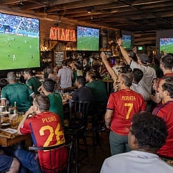 Soccer fans in Spain jerseys watch Spain vs Saudi Arabia on big screens at an Atlanta sports bar during the World Cup