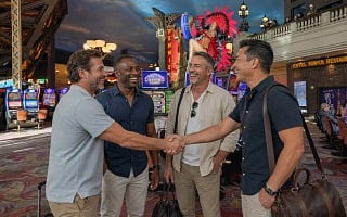 Four guys meeting up on the casino floor at Paris Las Vegas on a guys weekend