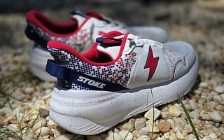 Stoke FO-MO 2Fiddy wide sneakers in red, white, and blue resting on gravel