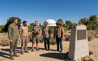 Group of guys standing near the Integratron dome in Joshua Tree California desert