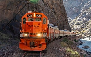 Royal Gorge Route Railroad locomotive 728 head on in the canyon with its headlights lit