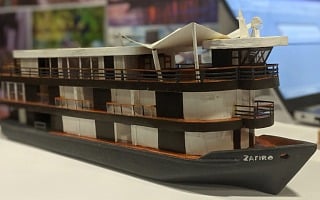 Scale model of the Zafiro Amazon riverboat on display at a travel trade show