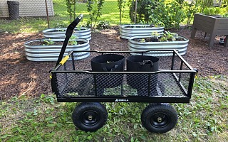 Gorilla GCG-1200 steel utility cart with grow bags in a backyard vegetable garden