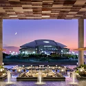 Clover Club lawn at Live! by Loews Arlington facing AT&T Stadium at dusk (photo credit: Loews Hotels)