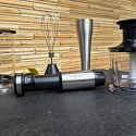 The FRESKO 4-in-1 immersion hand blender kit laid out on a table: measuring beaker with lid, whisk attachment, blending wand, motor body and the chopper bowl