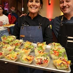 Two Kalahari chefs carrying a tray of salad cups at the Kalahari Food and Wine Festival