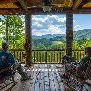guys relaxing on the porch of a smoky mountains cabin rental