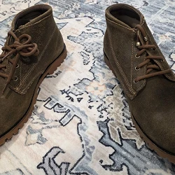 Wolverine 1000 Mile Legacy Cort Boot pair on a patterned rug, top-down view showing roughout suede chukka uppers with brown laces and rubber lug outsoles