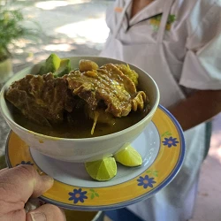 Bowl of Caribbean stew with avocado and lime served at an open-air restaurant (photo: James Hills)