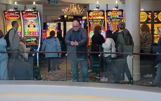 James checking his phone outside the casino on Norwegian Getaway